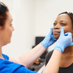 woman gets face examination by doctor botox