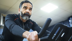 mature man exercise bike gym spin