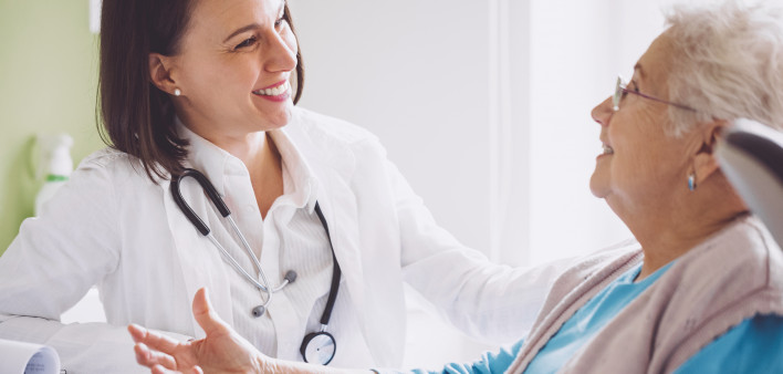 female doctor with older female patient