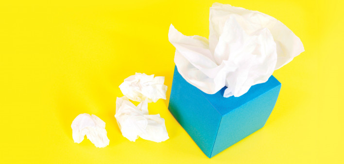 blue tissue box and white tissues on a yellow background