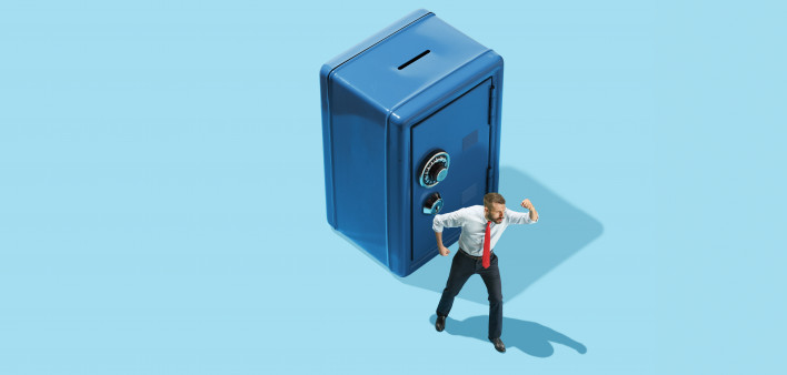 man in front of bank vault piggy bank