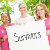 breast cancer awareness race holding sign survivors