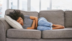 girl sick sleeping on couch
