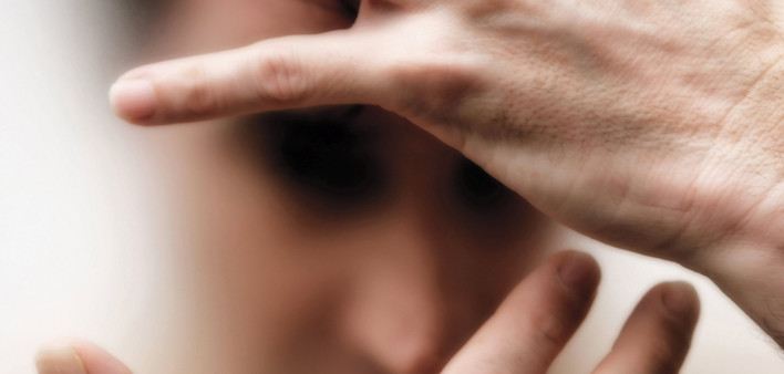man with blurred out face covering with his hands dramatic