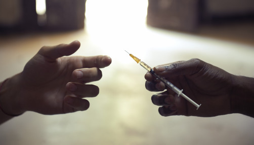 drug users passing a syringe