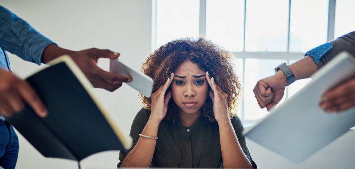 Shot of a stressed out young woman working in a demanding career