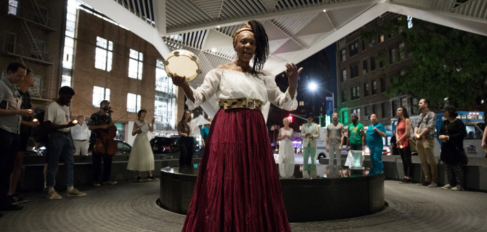 Goussy Célestin in Novenas for A Lost Hospita at the NYC AIDS Memorial