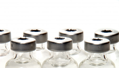 many vials with needle vaccine