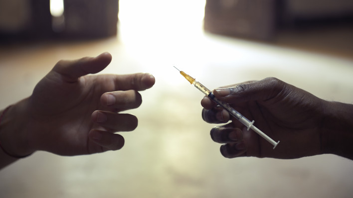 drug users passing a syringe