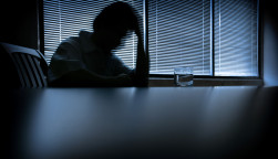 depressed man in a dark room 