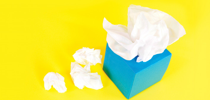 blue tissue box and white tissues on a yellow background
