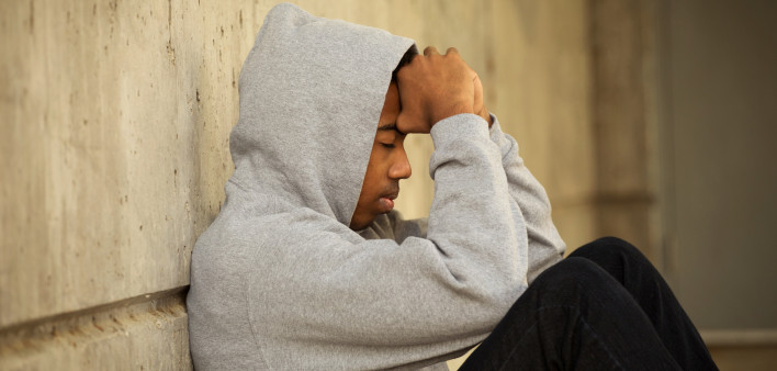 African American young teenage boy having problems.
