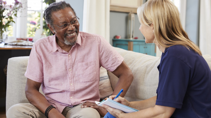 Female Support Worker Visits Senior Man At Home