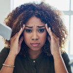 Shot of a stressed out young woman working in a demanding career
