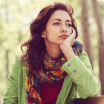 Unhappy girl sitting at bench