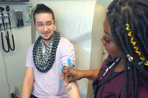 A nurse prepares a patient for a blood draw at Callen-Lorde’s Thea Spyer Center.