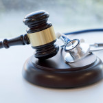 Gavel and stethoscope. medical jurisprudence. legal definition of medical malpractice. attorney. common errors doctors, nurses and hospitals make