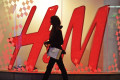 woman walking past H&M store