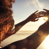 woman sun rise hands out happy