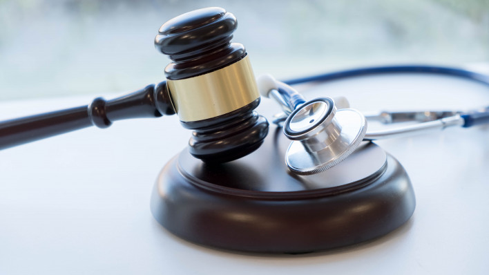 Gavel and stethoscope. medical jurisprudence. legal definition of medical malpractice. attorney. common errors doctors, nurses and hospitals make