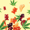 Colored gummies fly along with cannabis leaves. Chewing candies, gummies with CBD oil and THC. Colorful creative background,