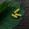 Kratom leaves and capsules