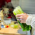 A woman making a Ceaser salad for dinner.