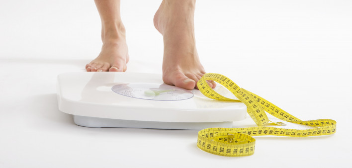 bare feet on scale and measuring tape