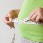 hands measuring waist measuring tape