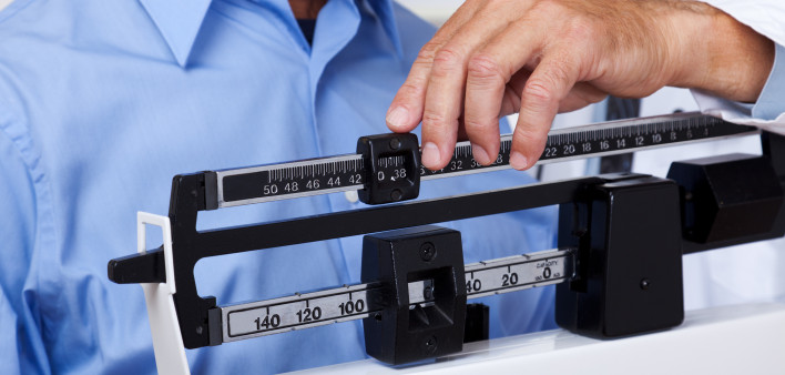 man getting weight checked on scale