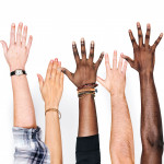 different race hands reaching upward