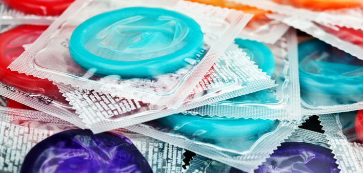 pile of mulit color condoms in clear plastic wrapers