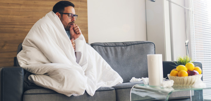 Young man suffering from cold and coughing