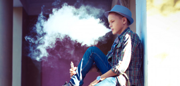 well dressed teen vaping e cigarette