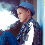well dressed teen vaping e cigarette
