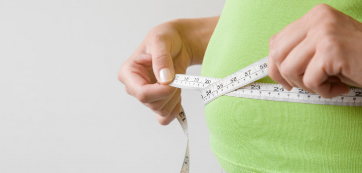 hands measuring waist measuring tape