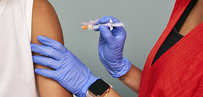 a vaccine is injected into arm