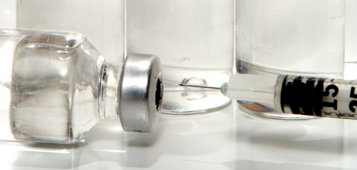 many vials with needle vaccine