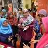 A group of women hear from a MAKNA staff at a World Cancer Day event held at a shopping mall in Kuala Lumpur, Malaysia