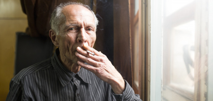elderly man smoking a cigarette