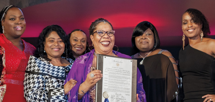 Dázon Dixon Diallo holds a proclamation honoring the 30th anniversary of SisterLove.