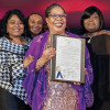Dázon Dixon Diallo holds a proclamation honoring the 30th anniversary of SisterLove.