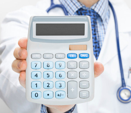 A hand holding up a calculator