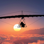 man hang gliding sunset clouds