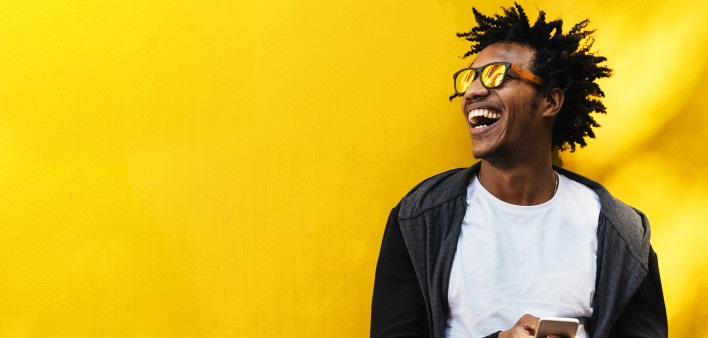 Portrait of handsome afro man using his mobile.