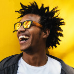 Portrait of handsome afro man using his mobile.