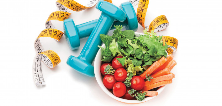 measuring tape dumbells and healthy salad