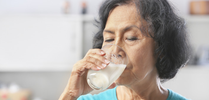 Senior Asian woman drinking milk at home(
