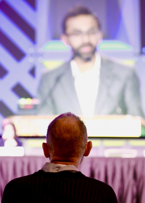 Timothy Ray Brown, aka the Berlin Patient, watches as Ravindra K. Gupta presents findings about a new case of likely cure of HIV at CROI 2019.