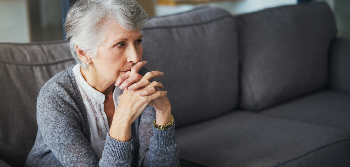 Shot of a senior woman suffering from stress at home